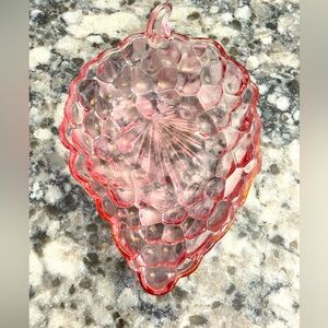 PINK GLASS DISH IN A STRAWBERRY SHAPE TEXTURED WITH A STARBURST ON THE BOTTOM
